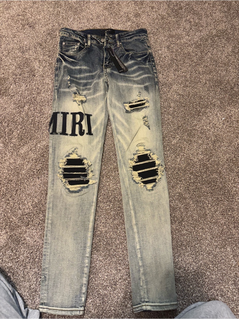 AMIRI Light Blue Distressed Straight Jeans with Black Patch Detail